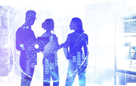 Two businesswomen and businessman working together in blurry office with double exposure of planet hologram. Globalization concept. Toned imageの写真素材