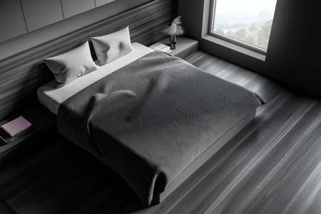 Top view of stylish bedroom with gray walls, concrete floor, comfortable master bed with two bedside...