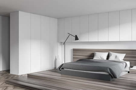 Corner of modern bedroom with white walls, wooden floor, comfortable master bed with two bedside tables. 3d renderingの写真素材
