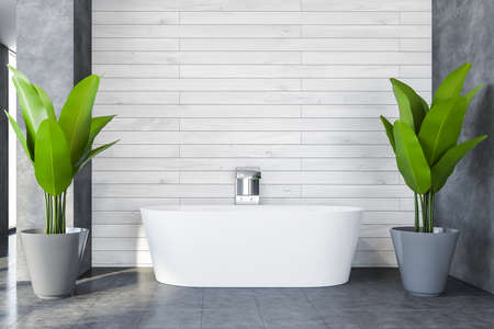 Interior of stylish bathroom with white and concrete walls, concrete floor and comfortable bathtub. 3d renderingの写真素材