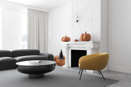 Corner of modern living room with white walls, concrete floor, gray sofa and armchair near coffee table and carved pumpkins on fireplace. Concept of Halloween. 3d renderingの写真素材