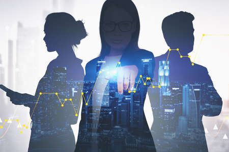 Businesswoman and her colleagues using stock market interface in blurry night city. Toned image
