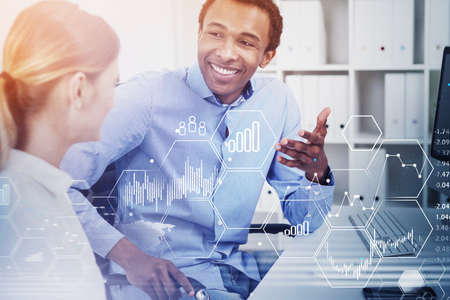 Portrait of businessman and businesswoman working together in blurry office with double exposure of...
