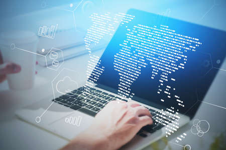 Close up businessman using laptop in blurry office with double exposure of world map. Toned image
