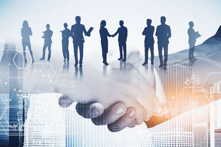 Close up of man and woman shaking hands in city with dobule exposure of their team and business interface. Toned imageの写真素材