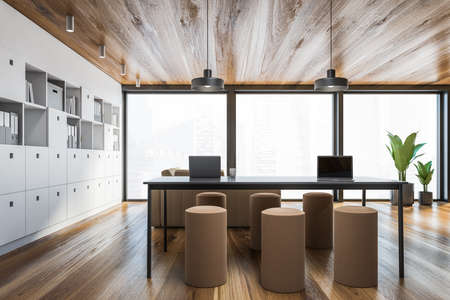 Interior of panoramic living room with white walls, wooden floor, table, comfortable beige sofa and bookcase. 3d renderingの写真素材
