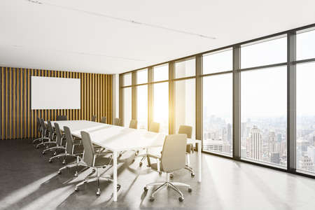 Corner of modern meeting room with white and woden walls, concrete floor, long conference table and mock up poster. 3d renderingの写真素材