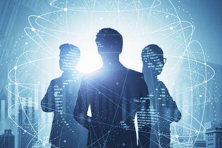 Silhouettes of three business people working in blurry city with double exposure of network...