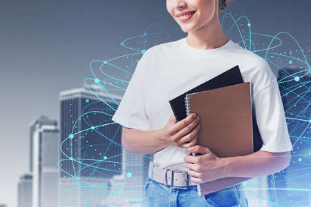Unrecognizable smiling businesswoman with folders standing in blurry city with double exposure of...