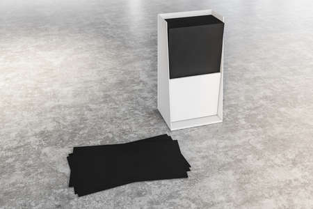 Stylish black blank business cards lying in white box and neat stack on concrete surface. Concept of...