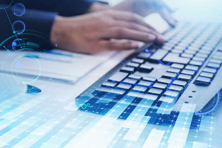 Hands of businessman typing on keyboard at white table with double exposure of network interface....