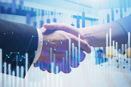 Close up of businessman and businesswoman shaking hands in blurry office with double exposure of...