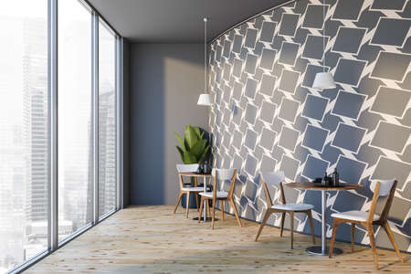 Corner of modern round restaurant with gray and white walls, wooden floor, round tables and white...