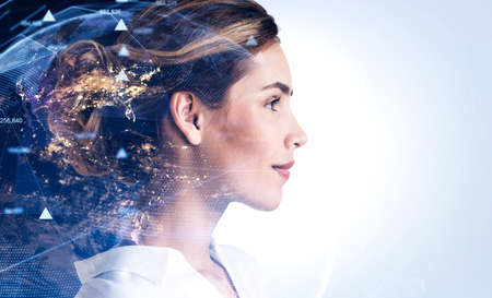 Side view of young woman with double exposure of Earth and network hologram. Toned image.の写真素材