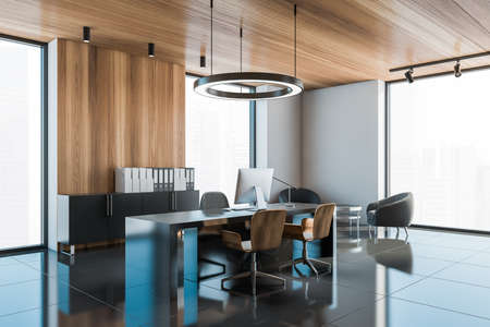 Corner of stylish CEO office with white and gray walls, black floor and black computer table. 3d renderingの写真素材