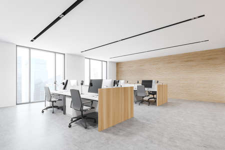 Comfortable workplace in stylish open space office corner with white and wooden walls, concrete floor and rows of computer tables. 3d renderingの写真素材