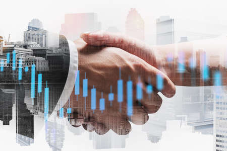 Businessman and businesswoman shaking hands in blurry city with double exposure of financial chart....