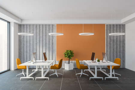 Interior of modern open space office with orange and gray walls, tiled floor and big computer tables...