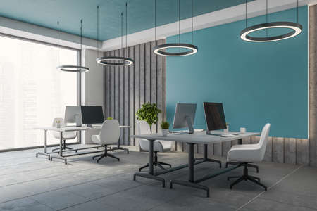 Corner of stylish open space office with blue and gray walls, tiled floor and big computer tables with white chairs. 3d renderingの写真素材