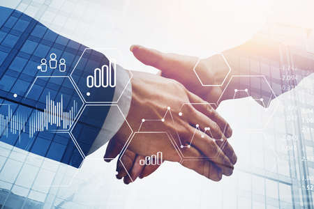 Businessman and businesswoman shaking hands in blurry city with double exposure of financial graph....