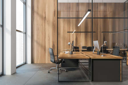 Wooden office tables with computers, workplace in wooden bright business room with big windows, view on the city skyscrapers no people, 3D rendering