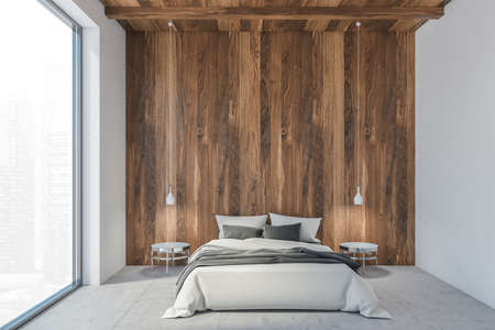 Bed in wooden white living room with a large window, sleeping room with white bed with linen. Pendant lamps and coffee table near bed, 3D rendering no peopleの写真素材