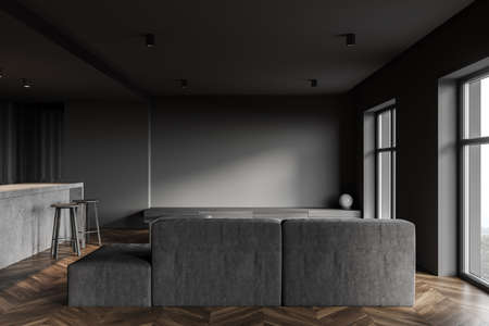 Interior of modern kitchen with dark gray walls, wooden floor, bar and sofa. 3d rendering