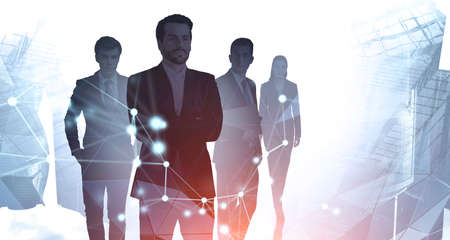Silhouettes of four business people working in blurry city with double exposure of financial graph....
