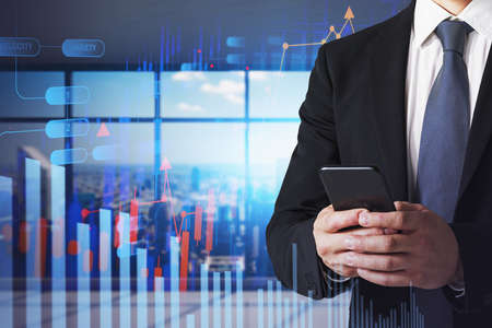 Portrait of unrecognizable businessman using smartphone in blurry office with double exposure of...
