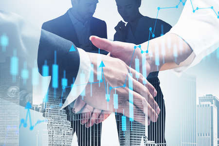 Close up of man and woman shaking hands in blurry city with business people in background and double...