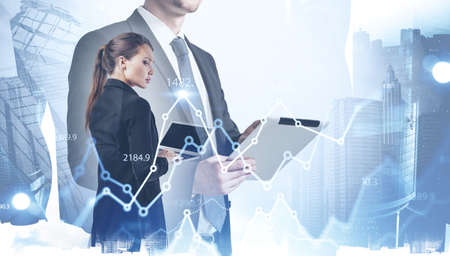Businessman and businesswoman working with documents in blurry city with double exposure of...