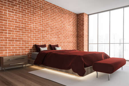 Corner of stylish master bedroom with brick walls, wooden floor and comfortable king size bed with red cover. 3d renderingの写真素材