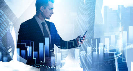 Side view of young businessman standing with smartphone in blurry city with dobule exposure of...