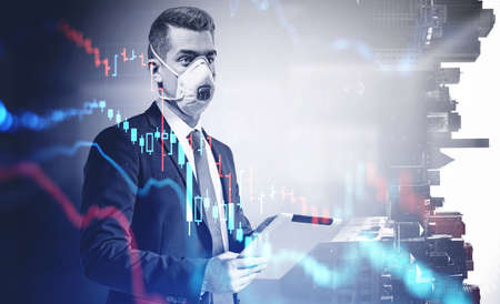 Young businessman in mask with tablet standing in blurry office with double exposure of falling...