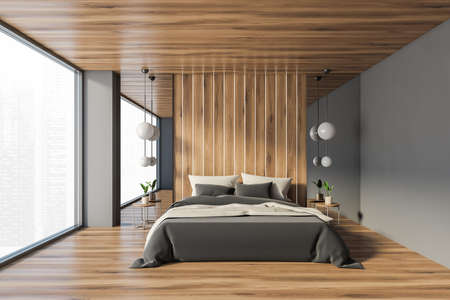 Interior of minimalistic master bedroom with gray and wooden walls, wooden floor and comfortable king size bed. 3d renderingの写真素材