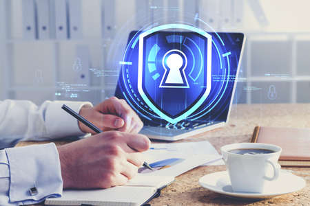 Hands of businessman working in blurry office with double exposure of immersive cyber security...