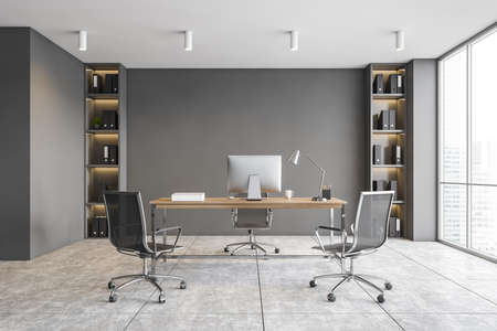 Interior of modern CEO office with gray walls, tiled floor, computer table and chairs for visitors. 3d renderingの写真素材