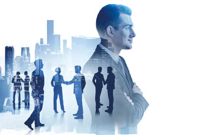 Confident young businessman working with his team in blurry city. Concept of partnership. Toned image double exposureの写真素材