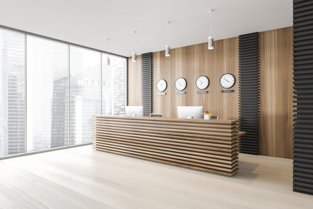 Corner of stylish office with gray and wooden walls, concrete floor, reception desk and clocks. Window with blurry cityscape. 3d renderingの写真素材