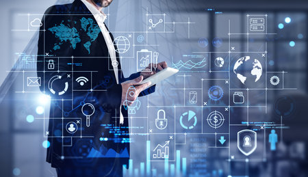 Close up of businessman using laptop in blurry office with with double exposure of network interface. Toned image.の写真素材