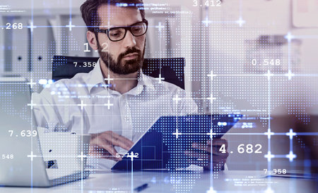 Young European businessman working in blurry office with double exposure of network interface. Toned imageの写真素材