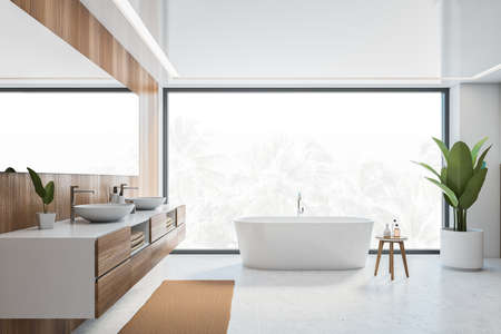 Wooden and white bathroom with bathtub, front view, large window with palms outdoors. Minimalist modern bathroom with sinks and mirror on white tiled floor 3D rendering, no peopleの写真素材