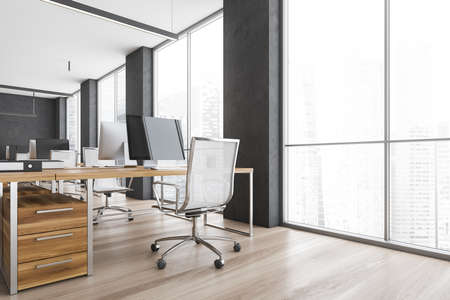 Wooden office room with armchairs and computers on the tables near windows. Gray and wooden office room with modern minimalist furniture, 3D rendering no peopleの写真素材