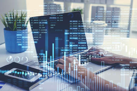 Businesswoman hands or stock trader analyzing stock graph chart by fibonacci indicator using laptop...