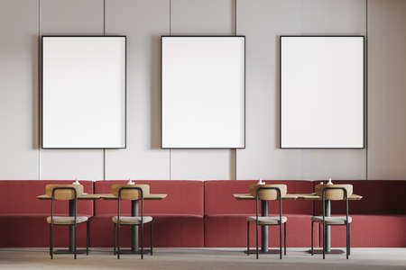 Mockup frames canvas above red sofa in a minimalist cafe. Seats in open space restaurant, wooden...