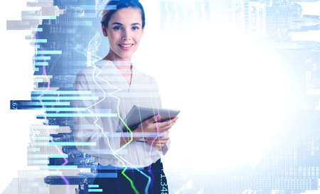 Smiling business woman using tablet with business report hologram. Business and financial success concept. double exposure. New York on backgroundの写真素材