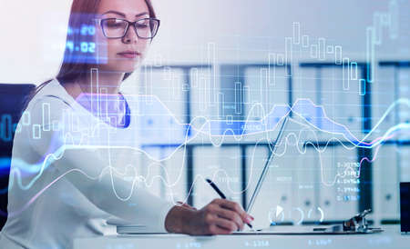 Business woman is making notes and trying to settle a new approach to deal with clients needs to boost the business and achieve exceptional financial results. Double exposure.の写真素材