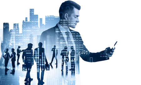 Businessman in formal suit checking stock market rates in smartphone. Hologram charts. Business and...