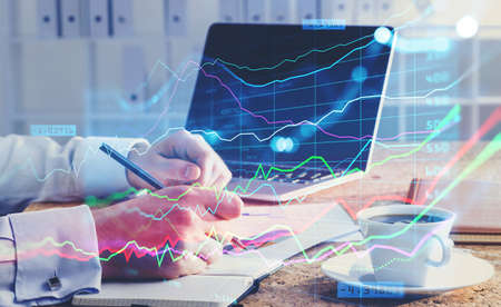 A financial analyst is making notes and trying to settle a new approach to boost the business and...