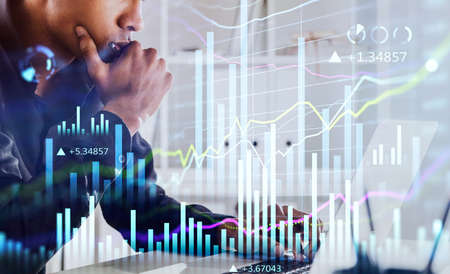 African American businessman or stock trader analyzing stock graph chart, side view stock trader...